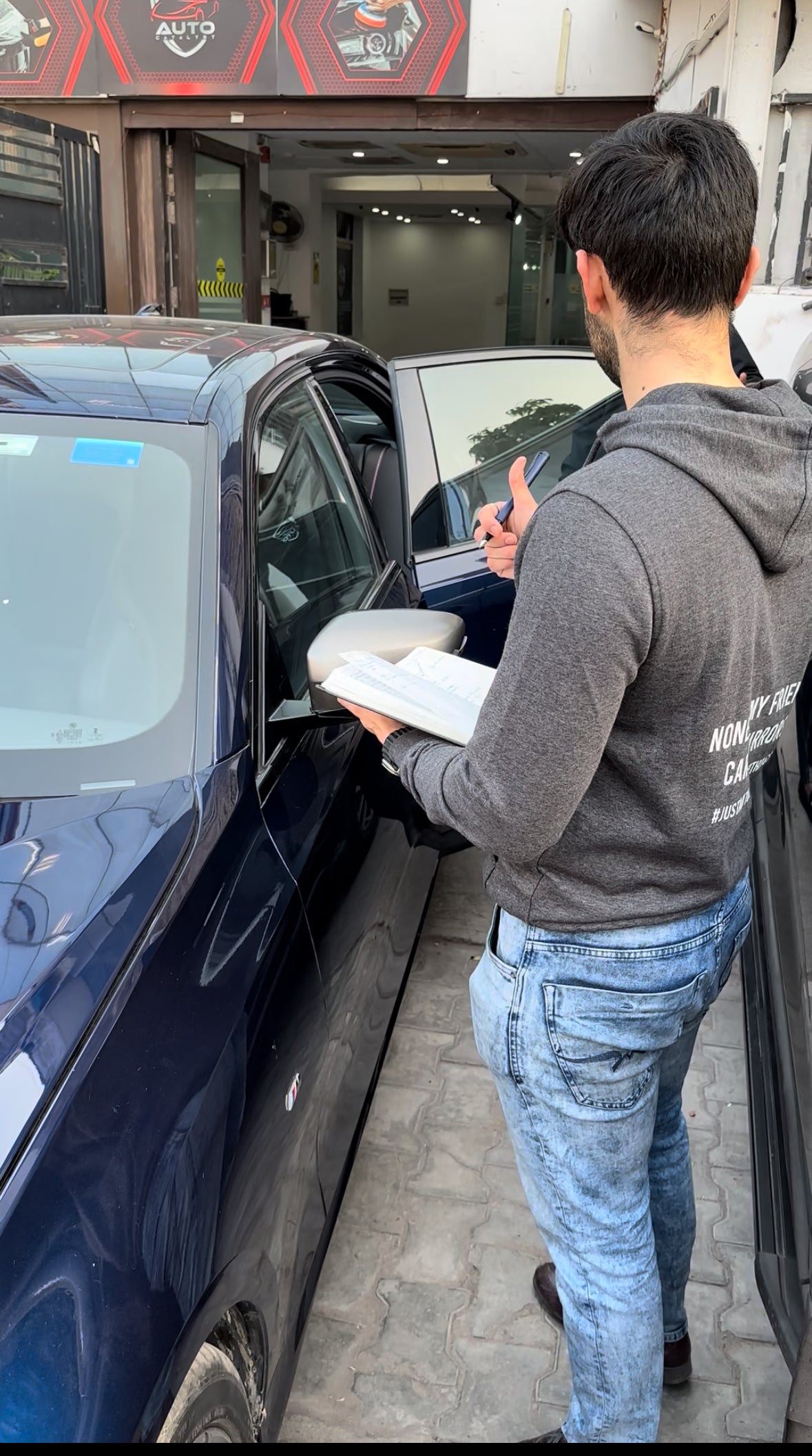 Anant Munjal inspecting automotive detailing and PPF installation